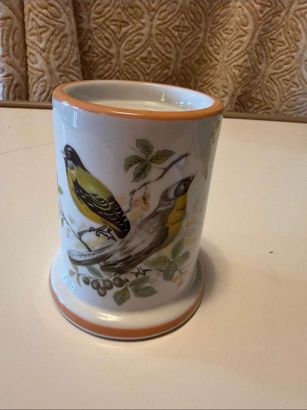Vintage ceramic candleholder with yellow finch on both sides.  Good condition.